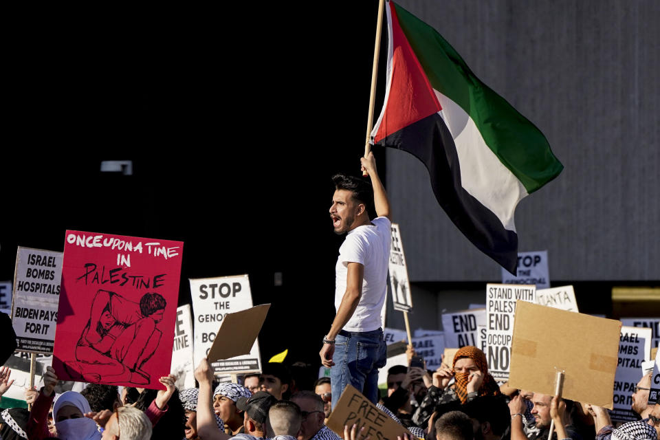 FILE - Pro-Palestinian supporters hold up signs during a demonstration, Friday, Oct. 20, 2023, in Atlanta, critical of Israel and the Biden administration's response to the Oct. 7, Hamas attack that sparked the current Israel–Hamas war. State lawmakers across the country are expected consider legislation related to the Israel-Hamas war in 2024. (AP Photo/Mike Stewart, File)