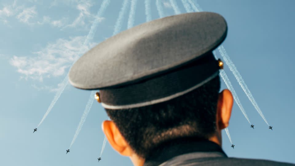 An officer watches an airshow by the "Black Eagles" air force team flying KAI T-50B Golden Eagle jets at the 2017 ADEX exhibition in Seoul, South Korea. - Nikita Teryoshin