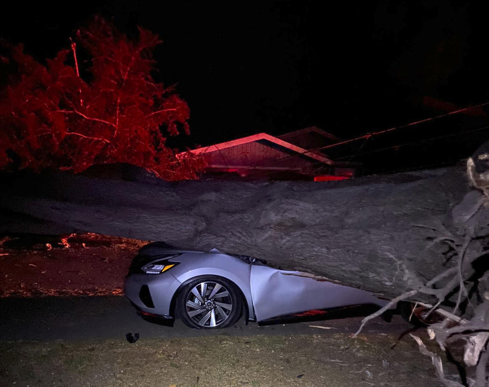 This early Monday, Oct. 11, 2021, photo provided by CalFire shows one of several vehicles damaged during a wind event in El Granada village in the coastal area of northern San Mateo County, Calif. (CalFire via AP)