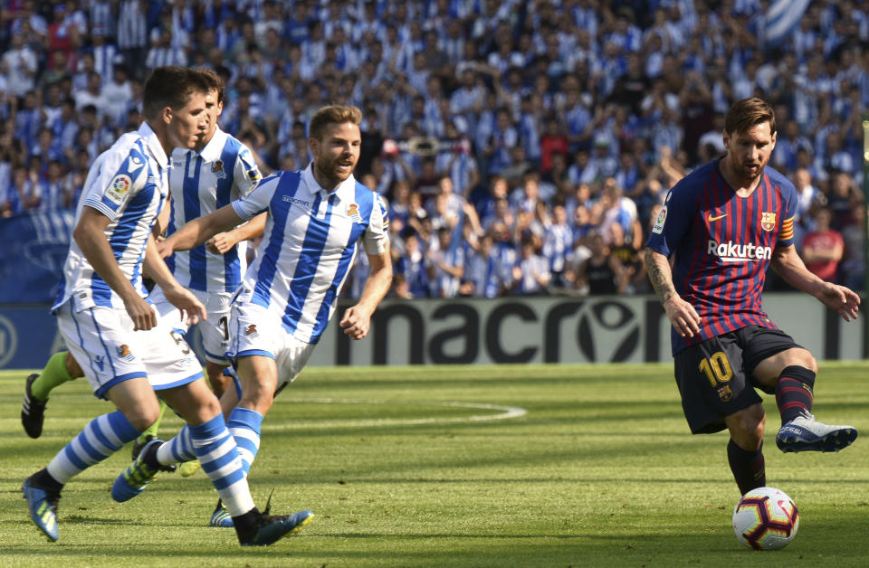 FC Barcelona's Lionel Messi, right, kicks the ball during a Spanish La Liga soccer match between Real Sociedad and FC Barcelona at the Anoeta stadium, in San Sebastian, northern Spain, Saturday, Sept. 15, 2018. (AP Photo/Jose Ignacio Unanue)