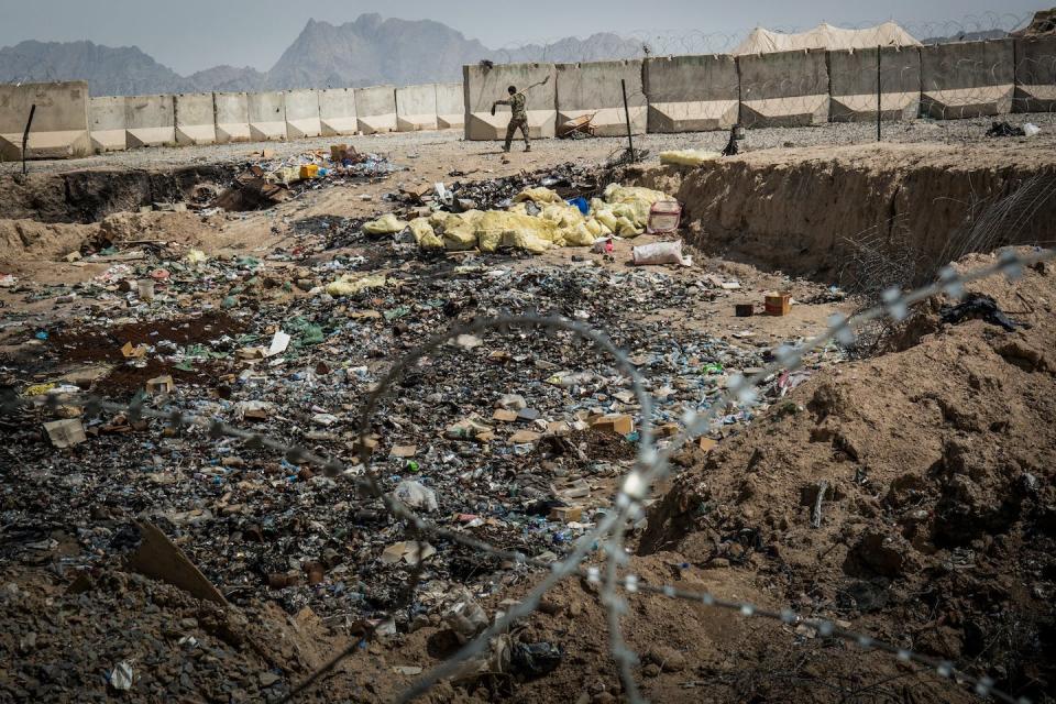 The remnants of a burn pit near a U.S. military base in Kandahar province, Afghanistan. <a href="https://www.gettyimages.com/detail/news-photo/soldier-in-the-afghan-national-army-walks-past-a-burn-pit-news-photo/168329521?adppopup=true" rel="nofollow noopener" target="_blank" data-ylk="slk:Andrew Burton/Getty Images;elm:context_link;itc:0;sec:content-canvas" class="link ">Andrew Burton/Getty Images</a>