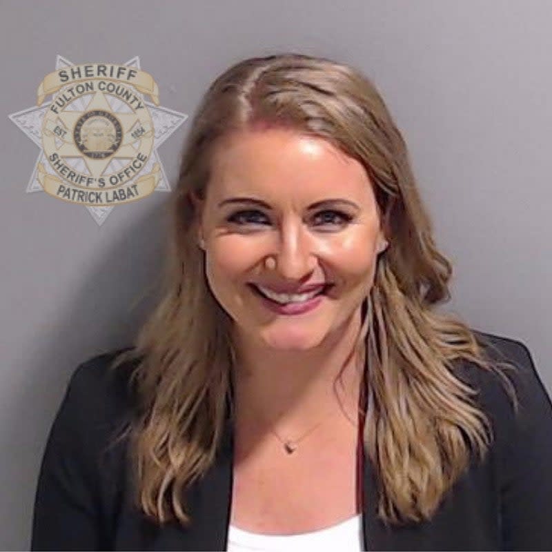 A mugshot of a smiling Jenna Ellis.