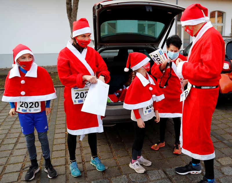 People dressed as Santa Claus race through the streets of Michendorf