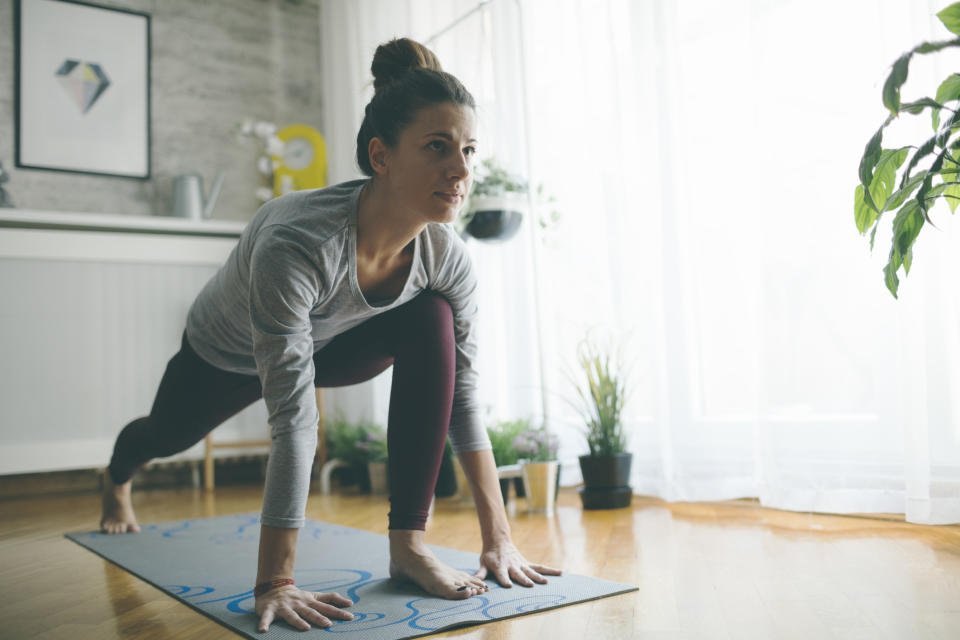 Woman exercising at home. (Getty Images)