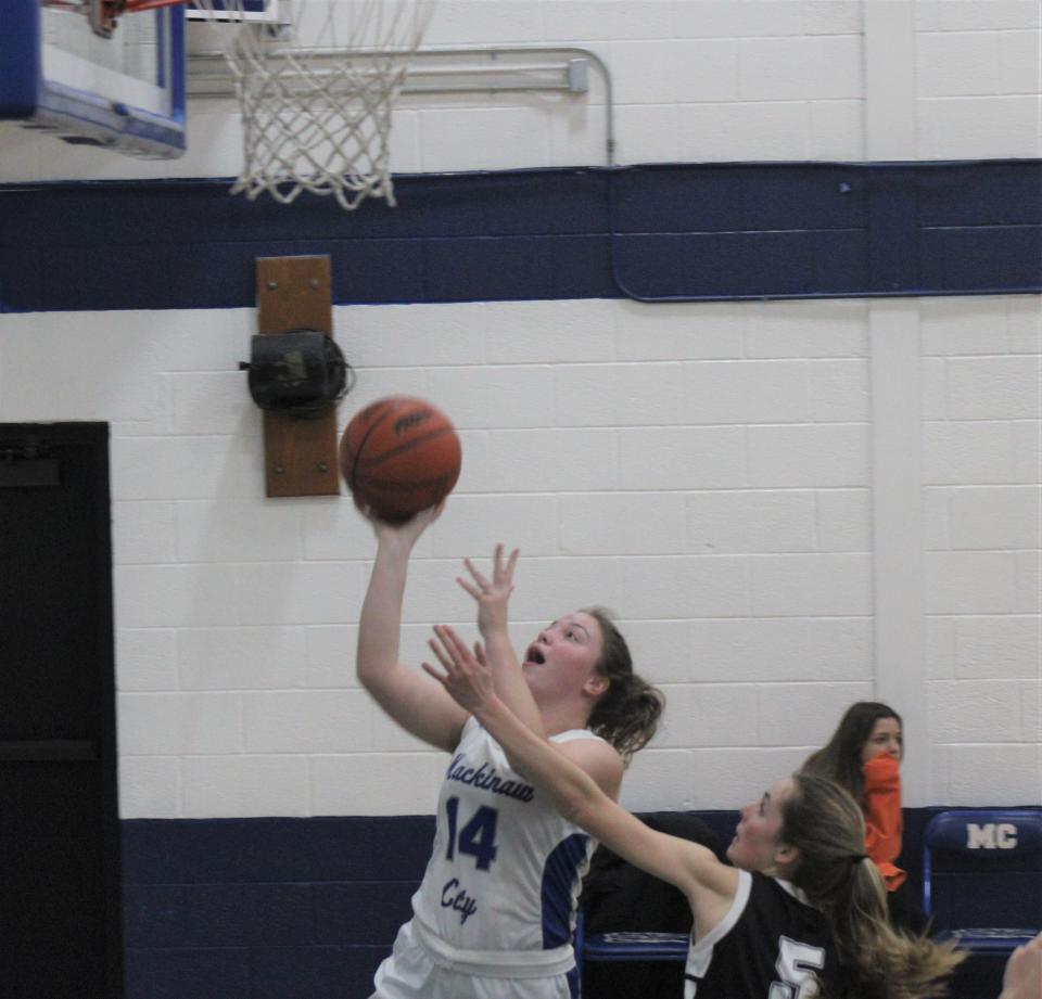 Mackinaw City junior forward Jersey Beauchamp (14) goes up strong for a layup during Tuesday's girls basketball contest against Ellsworth.