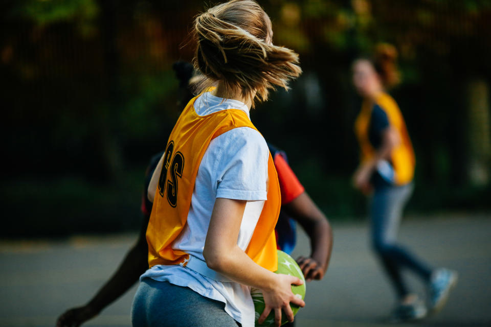 A stock image of netball player wearing an orange goal shooter singlet. A West Australian mother says her daughter was 'humiliated' at a netball game.