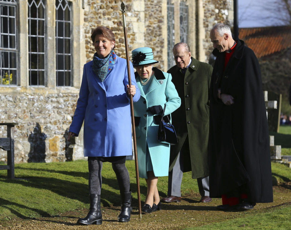 Britain's Queen Elizabeth II and her husband Duke of Edinburgh, centre, arrive at St Peter and St Paul at West Newton, England, Sunday Feb. 5, 2017. The Queen is to make history on Monday Feb. 6, when she becomes the first British monarch to reach the Sapphire Jubilee, marking the 65th. anniversary of her accession to the throne. (Gareth Fuller/PA via AP)