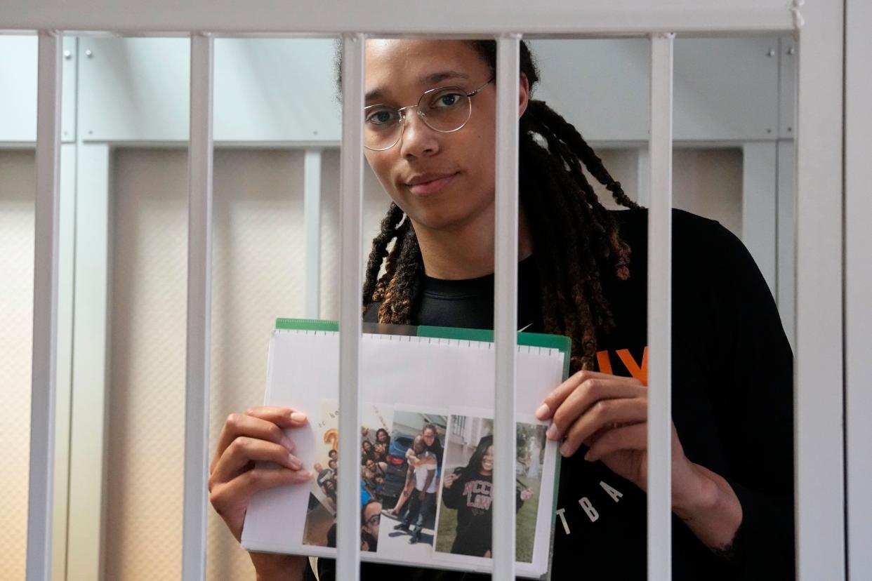 WNBA star and two-time Olympic gold medalist Brittney Griner holds images standing in a cage at a court room prior to a hearing, in Khimki just outside Moscow, Russia, Wednesday, July 27, 2022. American basketball star Brittney Griner returned Wednesday to a Russian courtroom for her drawn-out trial on drug charges that could bring her 10 years in prison of convicted. (AP Photo/Alexander Zemlianichenko, Pool)