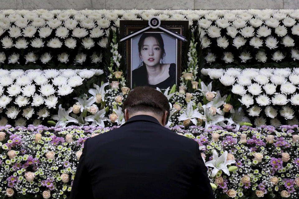 A South Korean man pays tribute to K-pop star Goo Hara at a memorial altar at the Seoul St. Mary's Hospital in Seoul, Monday, Nov. 25, 2019. Hara was found dead at her home in Seoul on Sunday, police said. (Chung Sung-Jun/Pool Photo via AP)