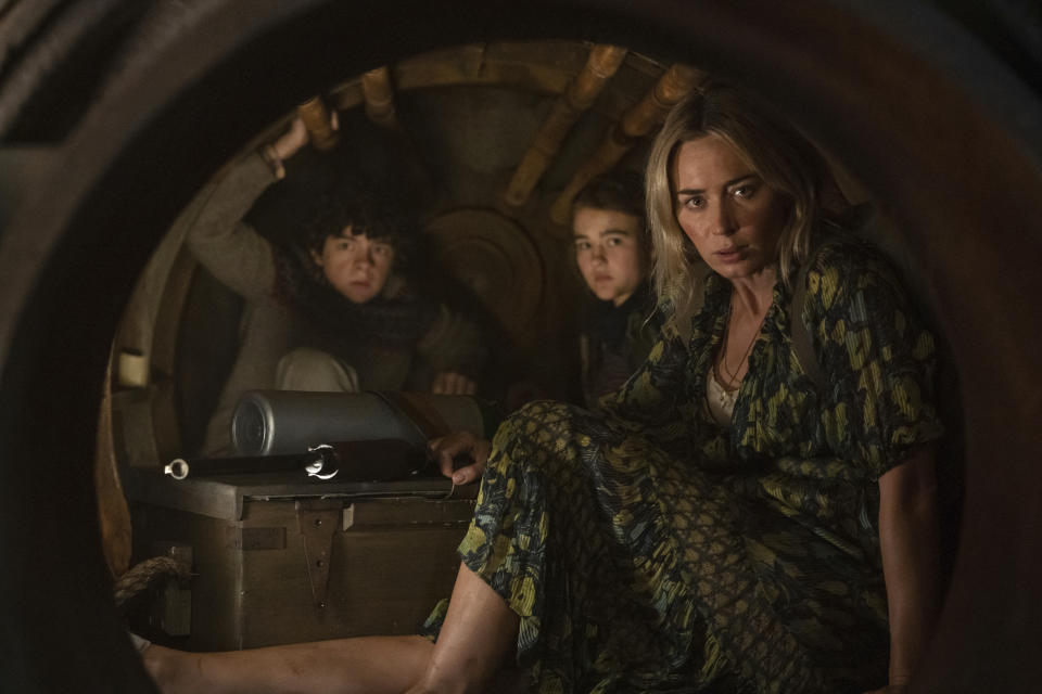 This image released by Paramount Pictures shows Noah Jupe, from left, Millicent Simmonds, and Emily Blunt in a scene from "A Quiet Place Part II." The entertainment industry, a business predicated on drawing crowds in theaters, cinemas and concert venues, braced Thursday, March 12, 2020, for a potential shutdown from the coronavirus as upcoming movies were canceled, festivals scuttled and live audiences eliminated from television shows. John Krasinski, writer and director of “A Quiet Place 2," announced Thursday that his film from Paramount Pictures would not open next week as planned but be postponed to as yet-announced date. (Jonny Cournoyer/Paramount Pictures via AP)