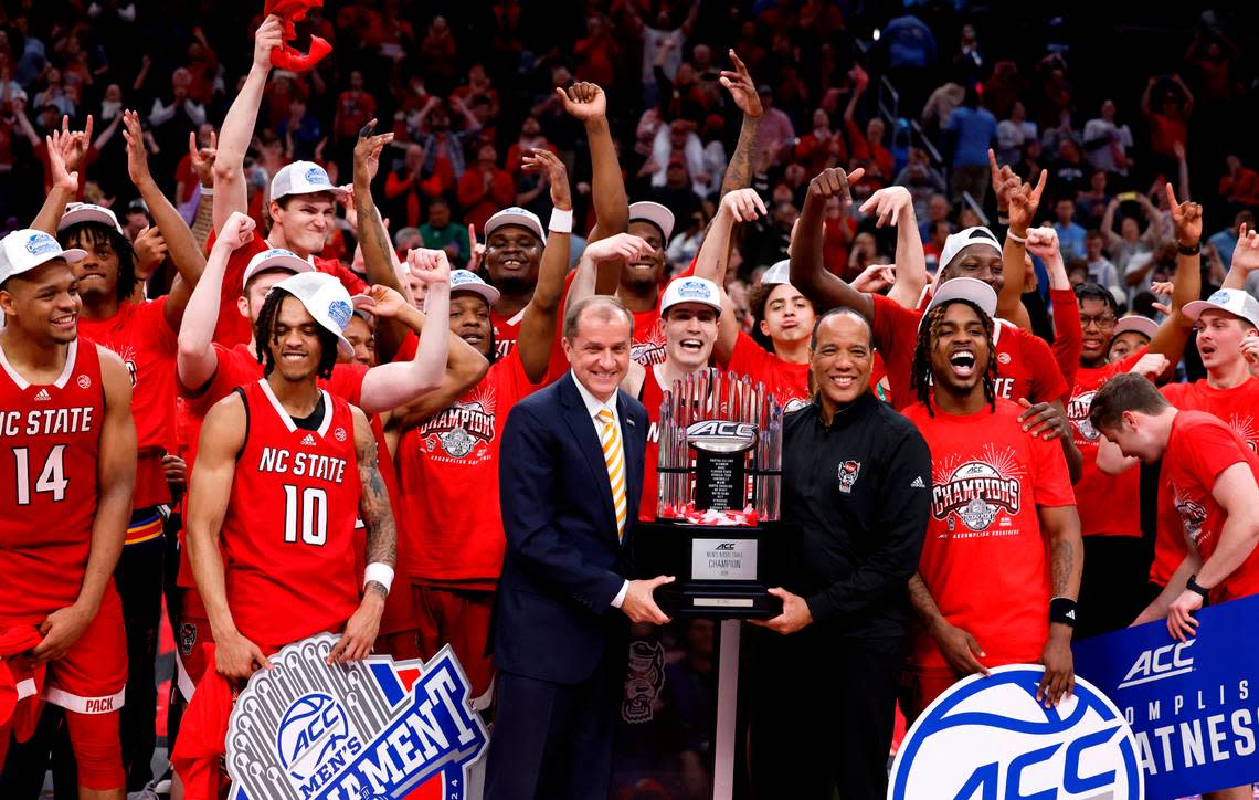 N.C. State’s head coach Kevin Keatts poses with the championship trophy with ACC commissioner Jim Phillips after N.C. State’s 84-76 victory over UNC in the championship game of the 2024 ACC Men’s Basketball Tournament at Capital One Arena in Washington, D.C., Saturday, March 16, 2024.
