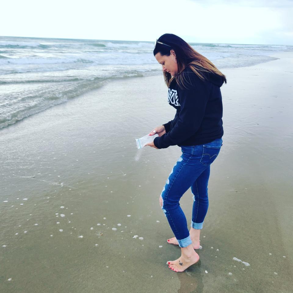 Jennifer Jones, the daughter of Freeda Pruitt, spreads her mother's ashes at her mom's favorite spot on the beach.