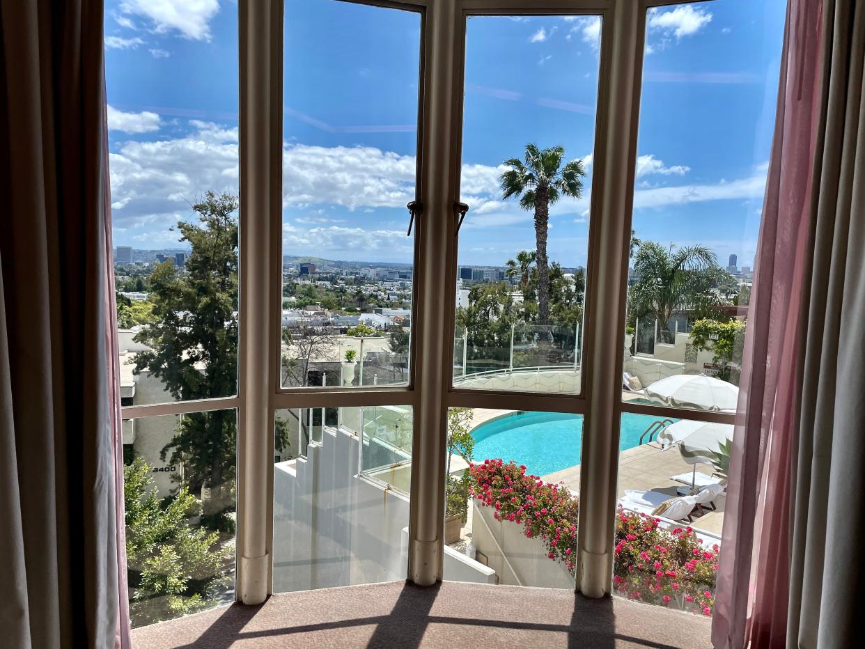 From the curved original French window, this Sunset Tower Hotel room has views over the original pool.