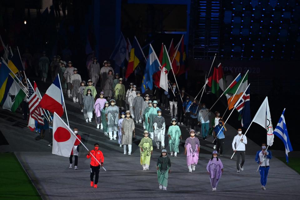 <p>Athletes carrying nations' flags attend the closing ceremony of the Tokyo 2020 Olympic Games, at the Olympic Stadium, in Tokyo, on August 8, 2021. (Photo by Tauseef MUSTAFA / AFP) (Photo by TAUSEEF MUSTAFA/AFP via Getty Images)</p> 