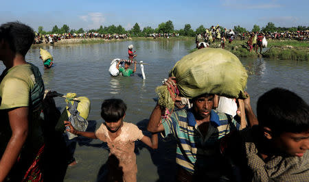 Rohingya refugees who fled from Myanmar make their way after crossing the border in Palang Khali, near Cox's Bazar, Bangladesh October 16, 2017. REUTERS/Zohra Bensemra