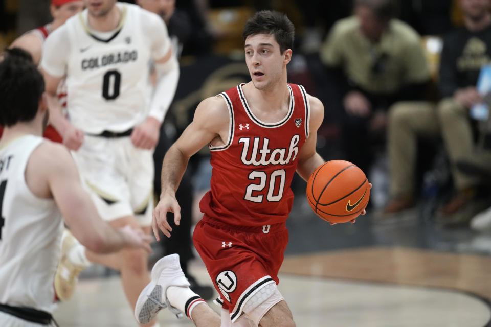 Utah guard Lazar Stefanovic pulls in the ball in the first half of an NCAA college basketball game against Colorado, Saturday, March 4, 2023, in Boulder, Colo. (AP Photo/David Zalubowski)