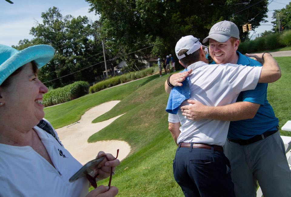 David Mills gets a hug from his dad, Rick Mills, as his mom, Karen, waits her turn after the fourth and final round of the Evansville Men's City Golf Tournament at Evansville Country Club Sunday afternoon, July 24, 2022. Mills came out on top by eight strokes (-17) and lead wire-to-wire in the tournament.