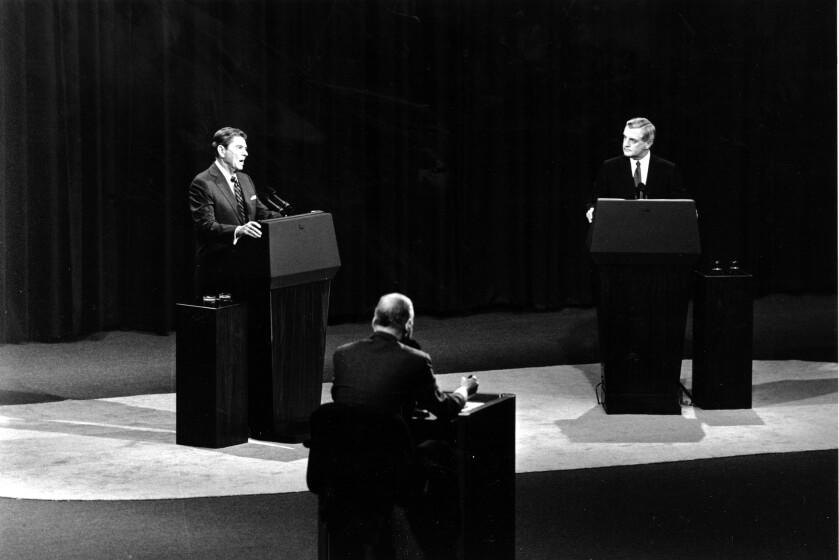 U.S. President Ronald Reagan, left, answers a question as Democratic candidate Walter Mondale listens during the second round of the 1984 Presidential debates in Kansas City, Mo. on Sunday, Oct. 21, 1984. In the center is the moderator Edwin Newman of the "Baltimore Sun." (AP Photo/David Longstreath)