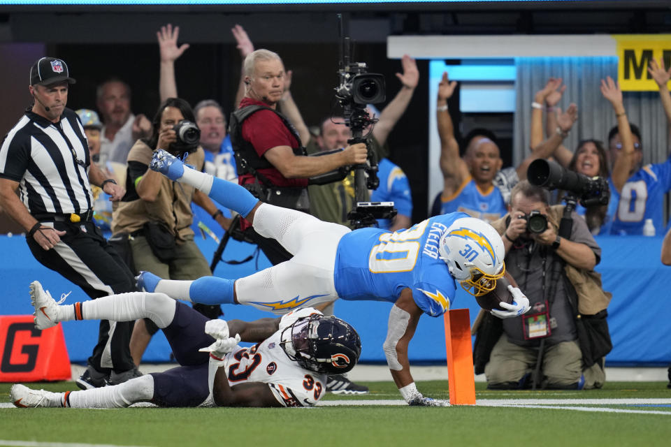 Los Angeles Chargers running back Austin Ekeler, above, scores a touchdown over Chicago Bears cornerback Jaylon Johnson during the first half of an NFL football game Sunday, Oct. 29, 2023, in Inglewood, Calif. (AP Photo/Ashley Landis)