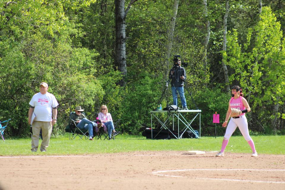 Monty Tech coach Dave Reid coaches against his granddaughter, Mia Curtis (third baseman), who plays for Oakmont. The teams came together for a Breast Cancer Awareness game in honor of Reid's wife, Betty, on May 13, 2024.