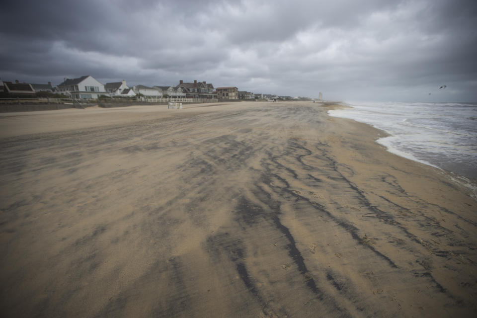 The Virginia Beach Oceanfront shoreline is marked with sediment from the Atlantic Ocean detailing where the storm surge peaked during high tide as Tropical Storm Ophelia makes her track north on Saturday, Sept. 23, 2023, in Virginia Beach, Va. (AP Photo/John C. Clark)