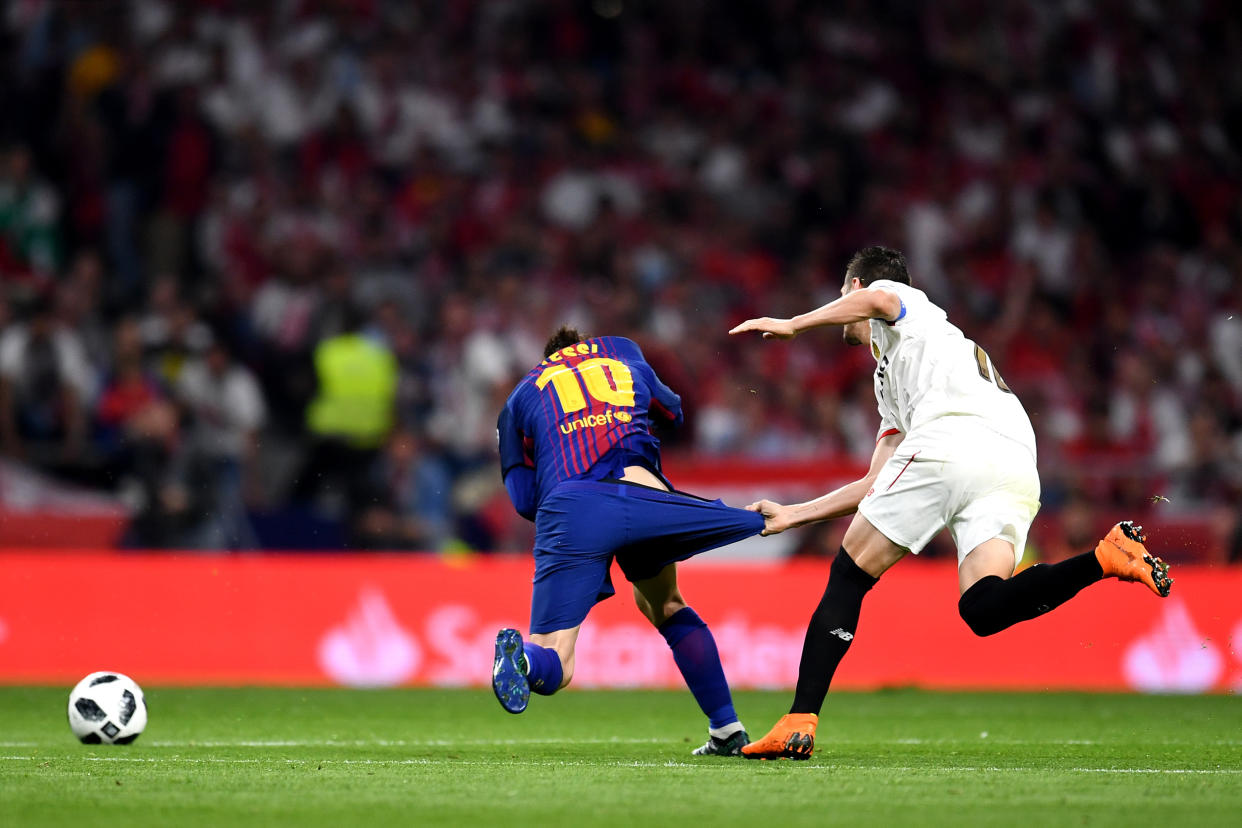 MADRID, SPAIN – APRIL 21: Lionel Messi of Barcelona is pulled down by his shorts by Sevilla’s Sergio Escudero during the Spanish Copa del Rey final. (Getty)