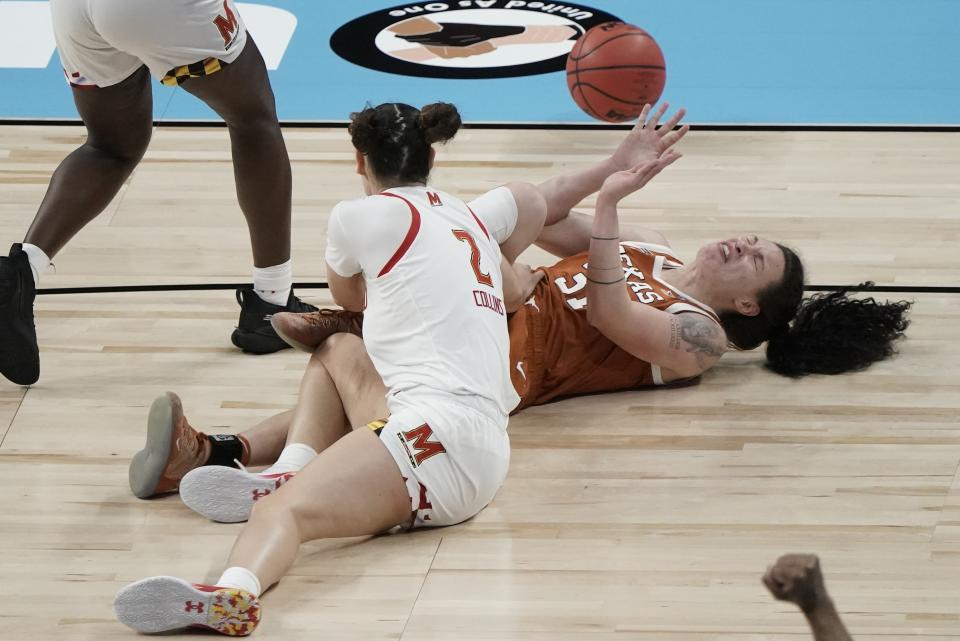 Maryland's Mimi Collins and Texas's Audrey Warren go after a loose ball during the second half of an NCAA college basketball game in the Sweet 16 round of the Women's NCAA tournament Sunday, March 28, 2021, at the Alamodome in San Antonio. (AP Photo/Morry Gash)