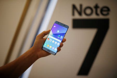 A model poses for photographs with a Galaxy Note 7 new smartphone during its launching ceremony in Seoul, South Korea, August 11, 2016.  REUTERS/Kim Hong-Ji/File Photo