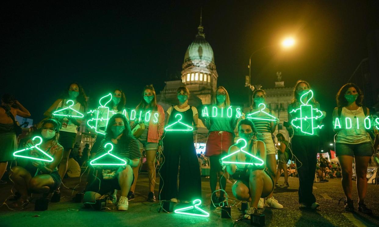 <span>Abortion-rights activists hold hangers, symbolizing illegal abortions, outside Congress in Buenos Aires, Argentina, on 30 December 2020.</span><span>Photograph: Victor Caivano/AP</span>