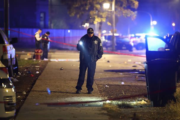 PHOTO: Police investigate the scene where as many as 14 people were reported to have been shot on Oct. 31, 2022, in Chicago. (Scott Olson/Getty Images)