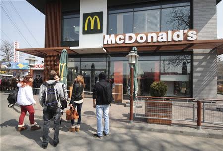 People gather outside a McDonald's restaurant, which was earlier closed for clients, in the Crimean city of Simferopol April 4, 2014. REUTERS/Stringer