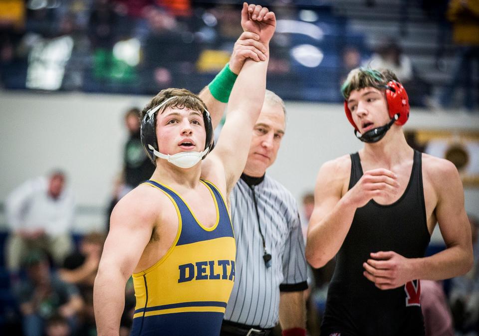 Delta's Braxton Russell wrestles Wapahani's Colten Gourley in the 170 pound weight class at Delta High School Saturday, Jan. 29, 2022. 