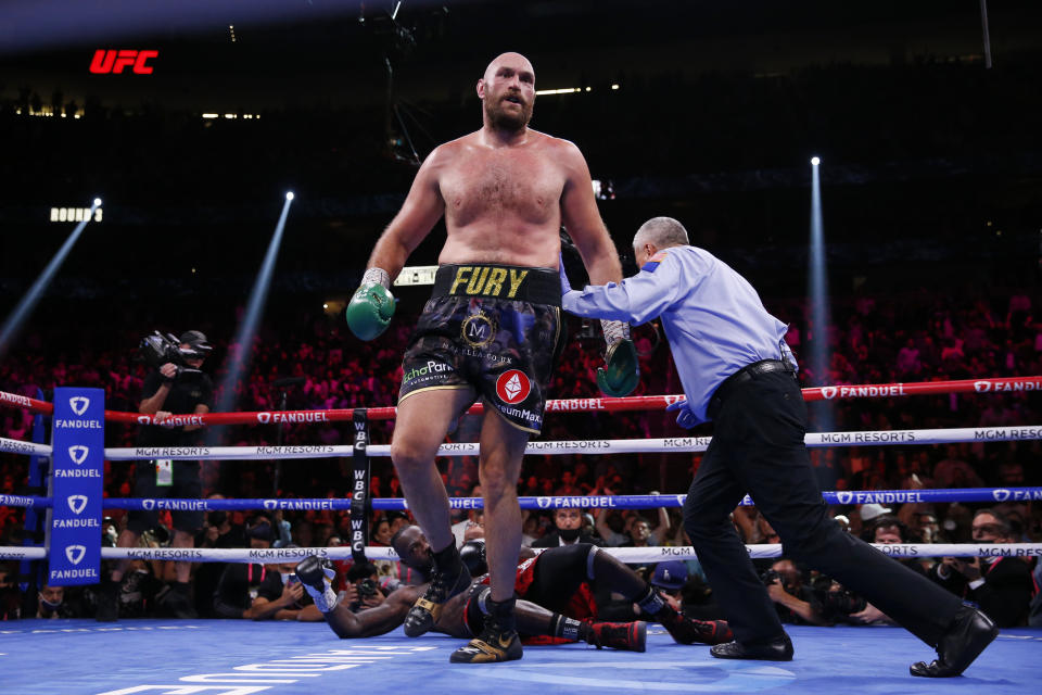 Tyson Fury, of England, knocks down Deontay Wilder in a heavyweight championship boxing match Saturday, Oct. 9, 2021, in Las Vegas. (AP Photo/Chase Stevens)