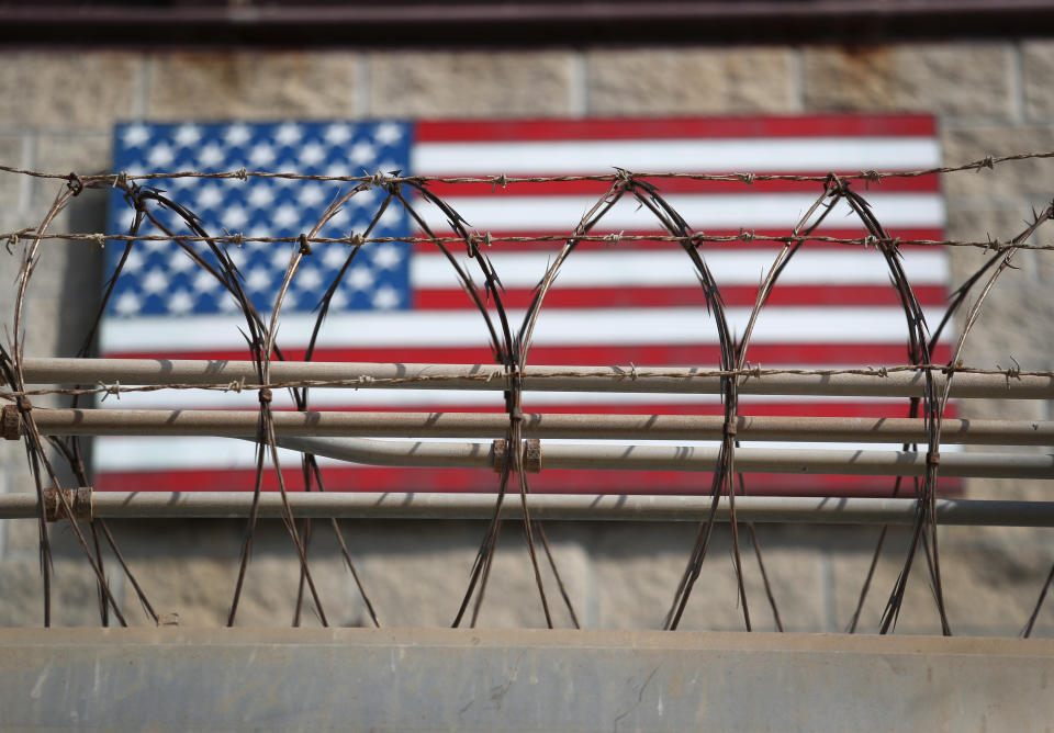 GUANTANAMO BAY, CUBA - OCTOBER 22: (EDITORS NOTE: Image has been reviewed by the U.S. Military prior to transmission.)   Razor wire lines the fence of the "Gitmo" maximum security detention center on October 22, 2016 at the U.S. Naval Station at Guantanamo Bay, Cuba. The U.S. military's Joint Task Force Guantanamo is still holding 60 detainees at the prison, down from a previous total of 780. On his second day in office in 2008 President Obama issued an executive order to close the prison, which has failed because of political opposition in the U.S.  (Photo by John Moore/Getty Images)