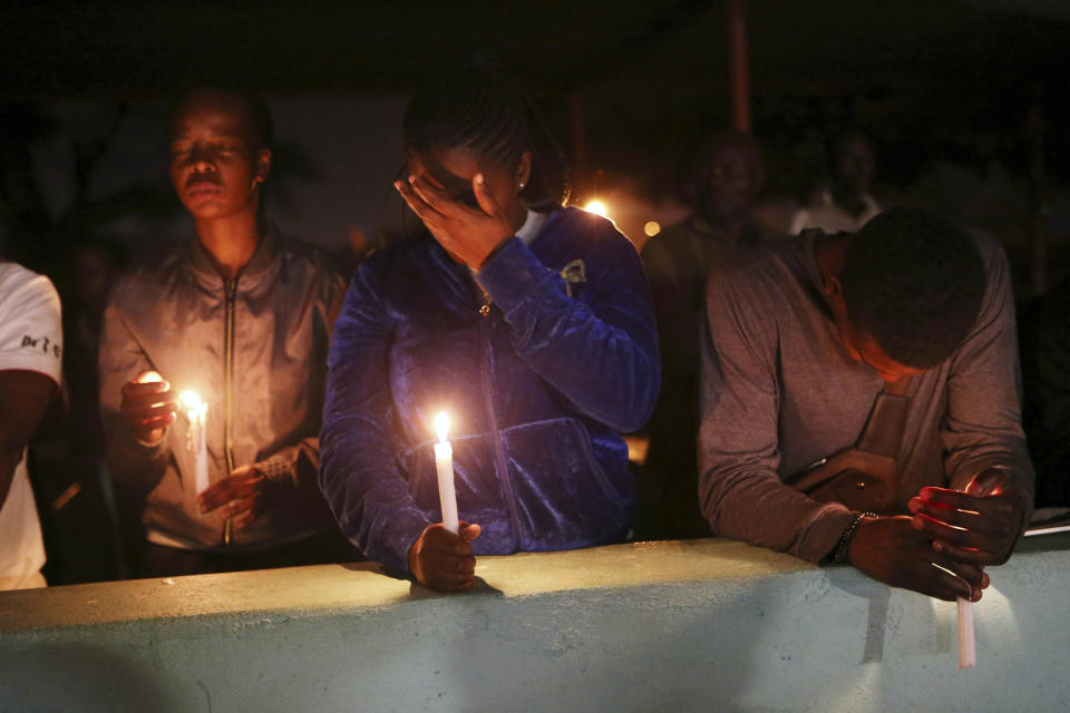 A night vigil prayer is held for a missing doctor, Peter Magombeyi, by well-wishers and fellow doctors at Harare hospital, Tuesday, Sept. 17, 2019. The Zimbabwe Hospitals Association has said that that their president, Peter Magombeyi, was abducted on Saturday, days after receiving threats on his phone. Magombeyi had expressed concerns to journalists about the poor state of Zimbabwe's hospitals.(AP Photo/Tsvangirayi Mukwazhi)