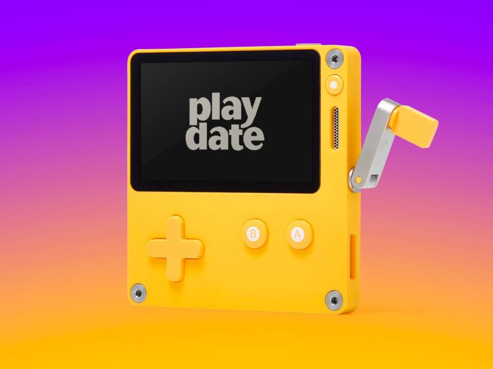playdate gaming console in front of a gradient background