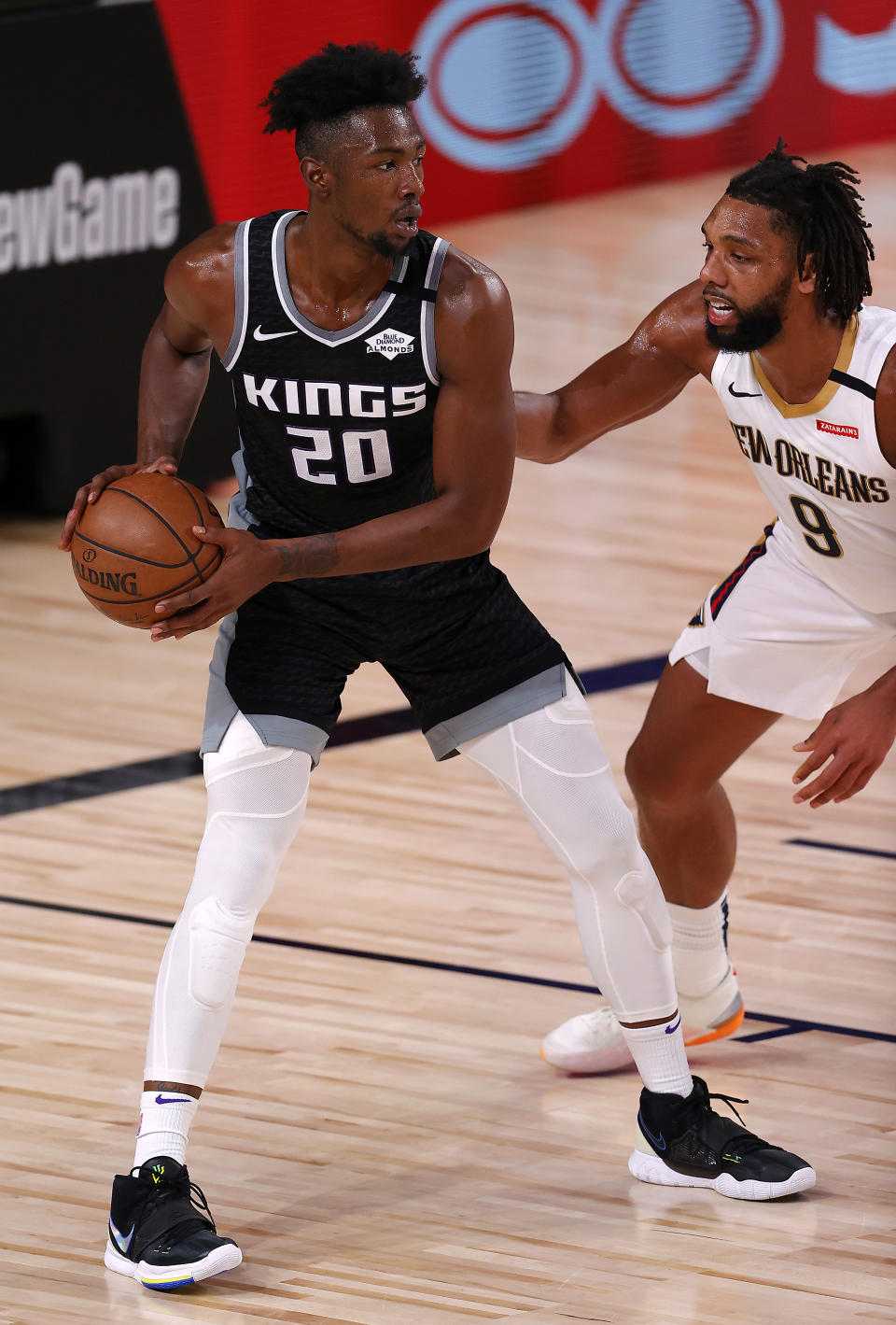 Sacramento Kings' Harry Giles III, left, is defended by New Orleans Pelicans' Jahlil Okafor during the second quarter of an NBA basketball game Tuesday, Aug. 11, 2020, in Lake Buena Vista, Fla. (Mike Ehrmann/Pool Photo via AP)