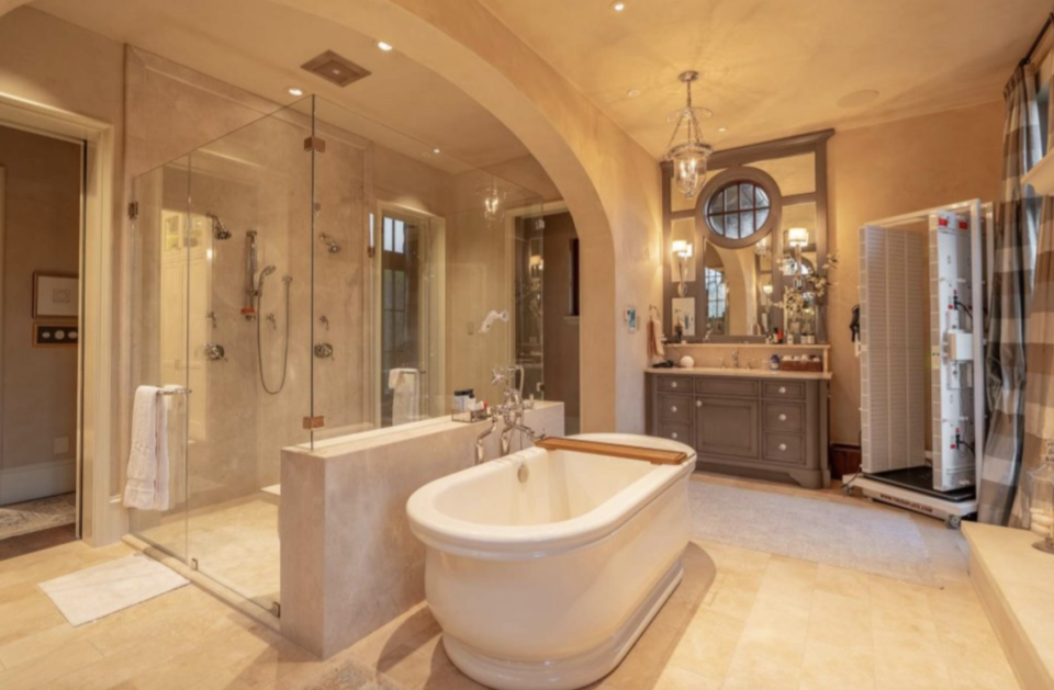 The bathroom in the primary bedroom features a soaking tub and fireplace.