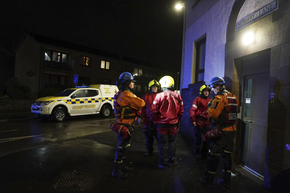 Emergency services in Stonehaven, Scotland, knock on doors and ask residents to evacuate due to flood warnings, Thursday, Oct. 19, 2023. Hundreds of people are being evacuated from their homes and schools have closed in parts of Scotland, as much of northern Europe braces for stormy weather, heavy rain and gale-force winds from the east. The U.K.’s weather forecaster, the Met Office, issued a rare red alert, the highest level of weather warning, for parts of Scotland. (Andrew Milligan/PA via AP)