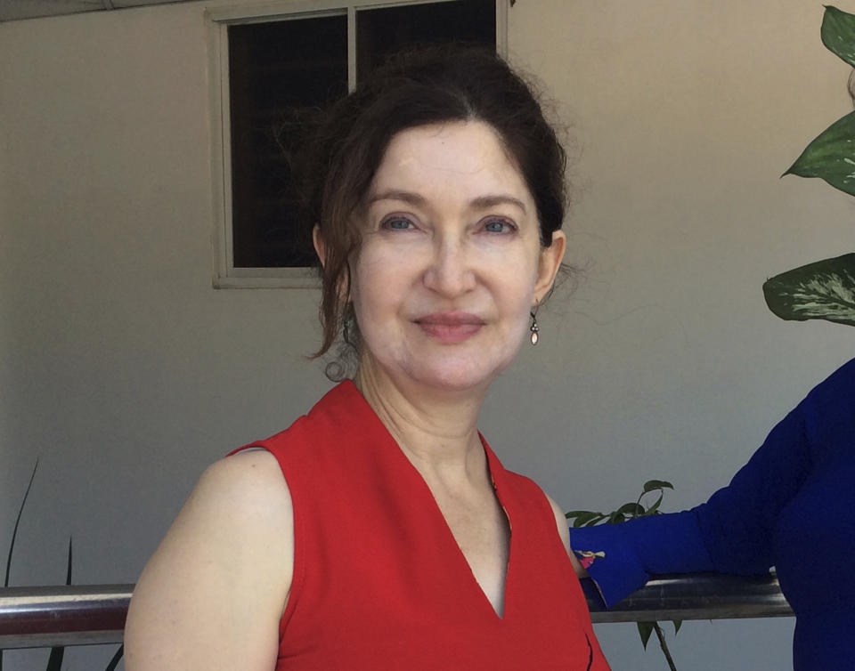 In this October 2018 photo provided by Cheryl Inzunza Blum, of Tucson, Ariz., the immigration lawyer on contract with the federal government poses for a photo in Vung Tau, Vietnam. Blum said she hasn’t been paid for weeks even though she is still working, so she is turning to Airbnb as a source of income during the partial government shutdown. (John Martin Smith/Courtesy of Blum via AP)