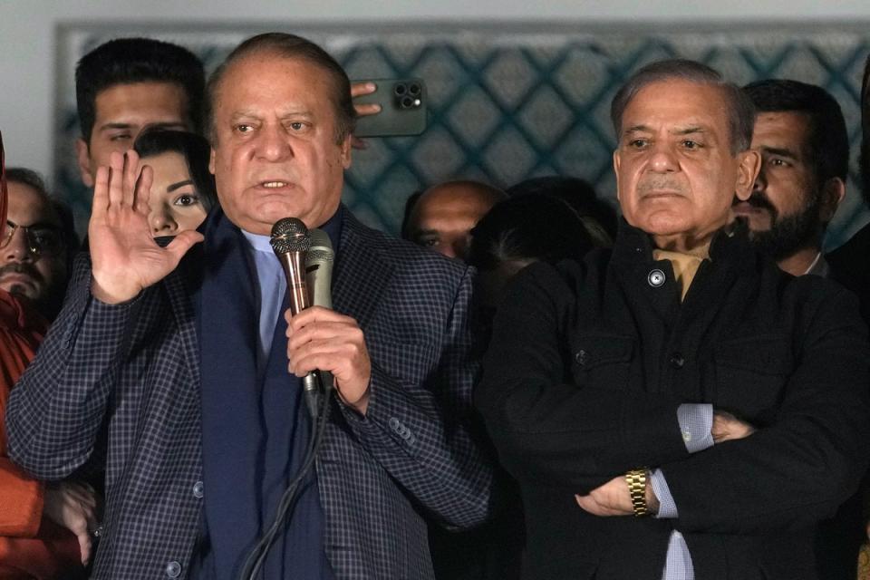 Pakistan’s former prime minister Nawaz Sharif, left, addresses supporters next to his newly-elected brother following initial results of the country's parliamentary election, in Lahore (AP)
