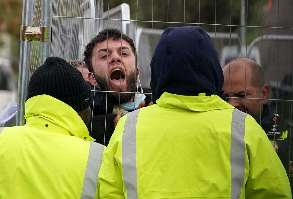 A migrant at Manston attempting to communicate with journalists (PA)