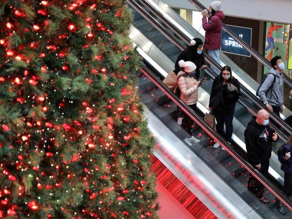 FILE PHOTO: Shoppers wearing mandatory masks pass Christmas Tree at Eaton Centre mall in downtown Toronto