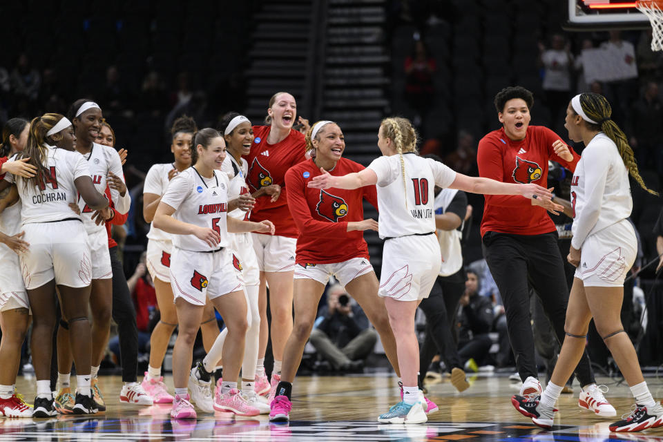 Louisville players embrace guard Hailey Van Lith (10) after the team's win over Mississippi in a Sweet 16 college basketball game at the women's NCAA Tournament in Seattle, Friday, March 24, 2023. (AP Photo/Caean Couto)