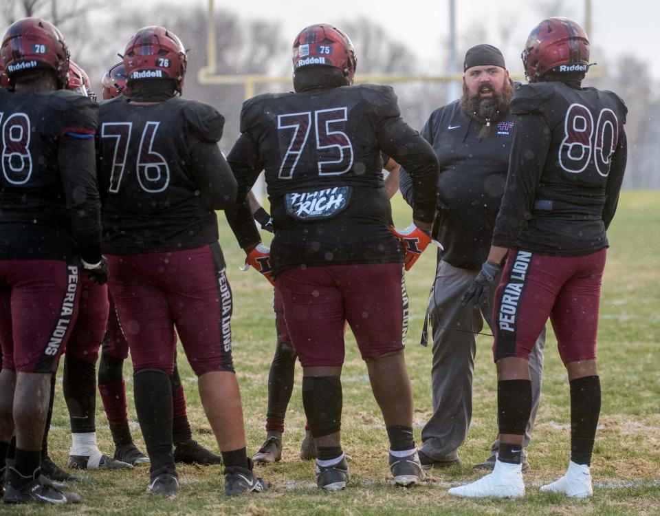 Peoria High head coach Tim Thornton talks with his team late in the first half of their Class 5A football state semifinal against Morris on Saturday, Nov. 19, 2022 at Peoria Stadium.