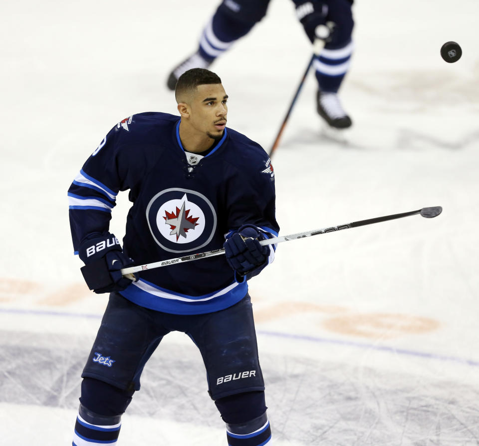 Jan 13, 2015; Winnipeg, Manitoba, CAN; Winnipeg Jets forward Evander Kane (9) plays with the puck prior to the game against the Florida Panthers at MTS Centre. (Bruce Fedyck-USA TODAY Sports)