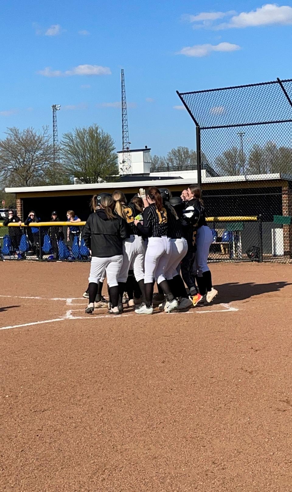 The Eagles congratulate Nettie Gallant after her two-run homer.