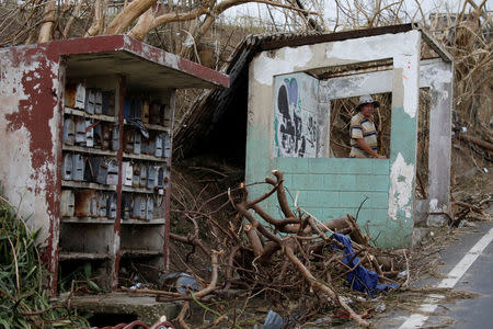 A man stands at a damaged bus stop after the area was hit by Hurricane Maria in Yabucoa, Puerto Rico September 22, 2017. REUTERS/Carlos Garcia Rawlins