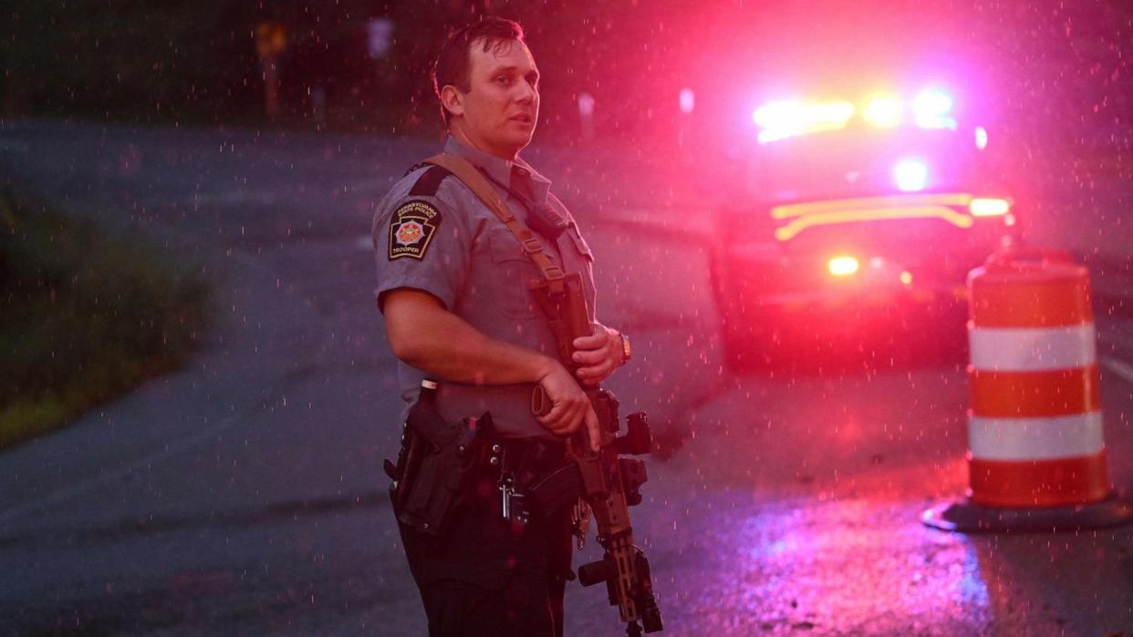 PHOTO: Police with rifles monitor a wooded perimeter in the rain on day 10 of a manhunt for convicted murderer Danelo Cavalcante on Sept. 9, 2023, in Kennett Square, Pennsylvania. Cavalcante escaped from Chester County Prison on August 31. (Mark Makela/Getty Images)