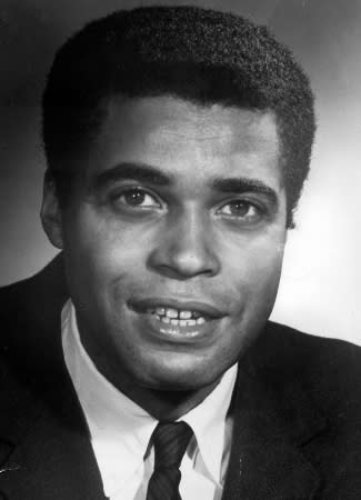 A black-and-white photo showing James Earl Jones with a suit and tie and short hair.